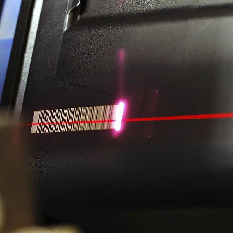 Inline DPM scanner instantly verifying the laser-marked barcode on a transmission gear
