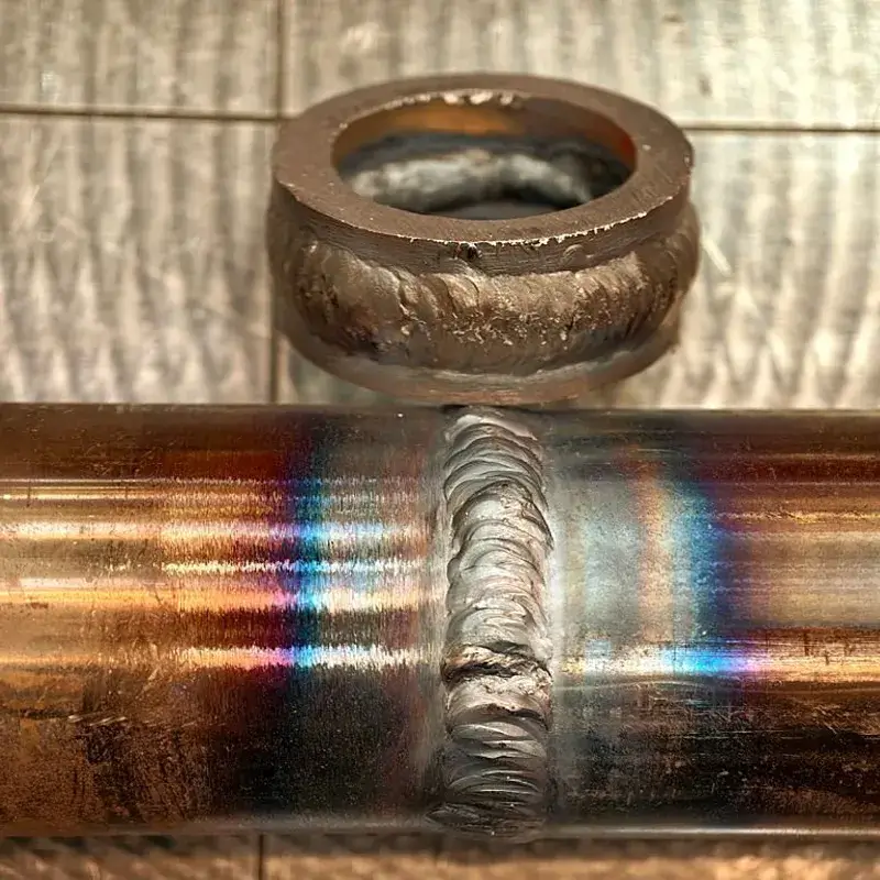 Post-weld laser ablation removing heat tint from stainless steel joint